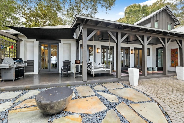 rear view of house featuring a patio, ceiling fan, and french doors