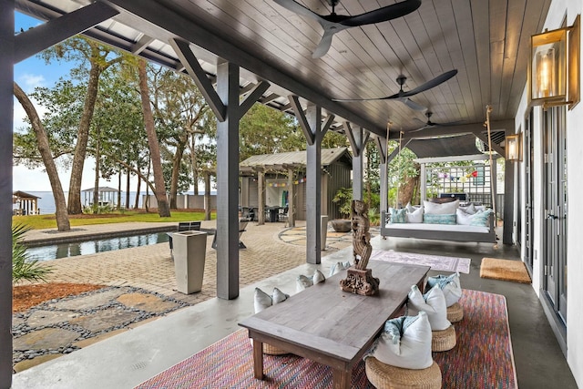 view of patio / terrace featuring an outdoor hangout area, ceiling fan, and a water view