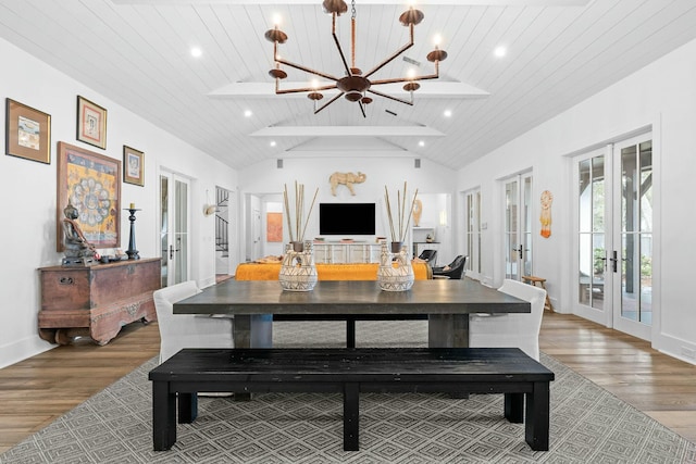 dining room featuring french doors, lofted ceiling, wood-type flooring, wooden ceiling, and a notable chandelier