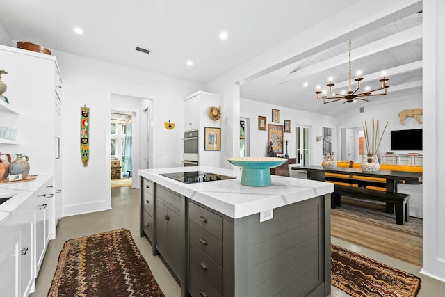 kitchen with white cabinetry, stainless steel oven, light stone counters, black electric cooktop, and gray cabinets