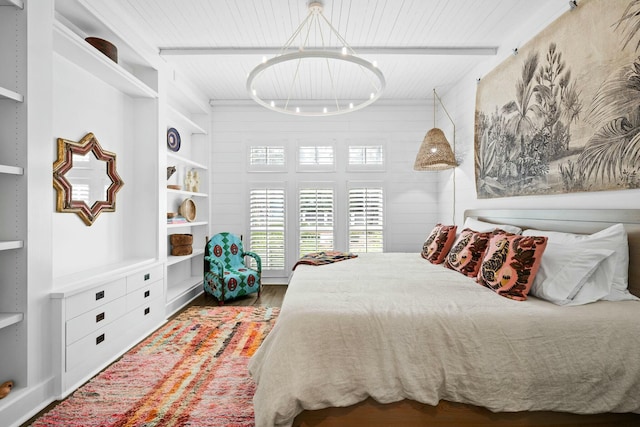 bedroom featuring hardwood / wood-style floors, beam ceiling, and wooden ceiling