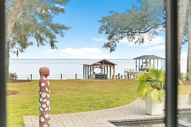 dock area featuring a water view and a yard