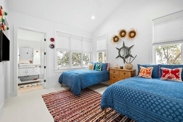 bedroom featuring lofted ceiling and ensuite bath