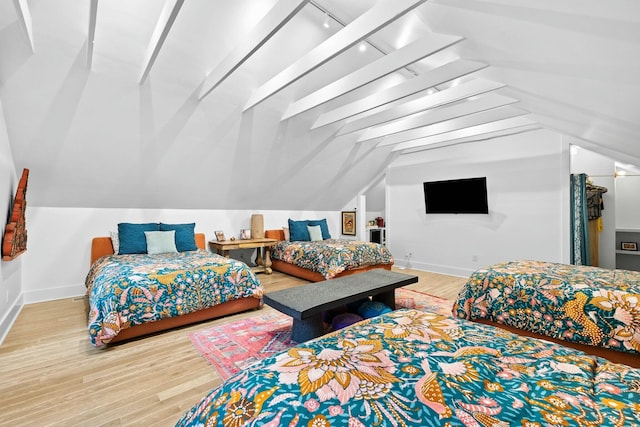 bedroom with vaulted ceiling and hardwood / wood-style floors