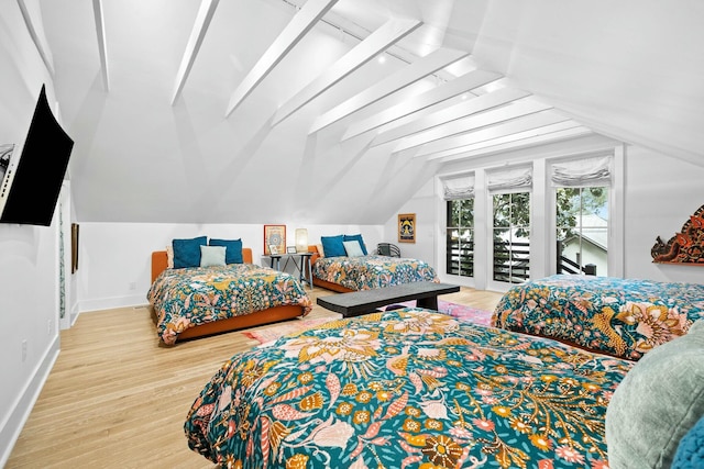 bedroom featuring vaulted ceiling, hardwood / wood-style floors, and access to outside