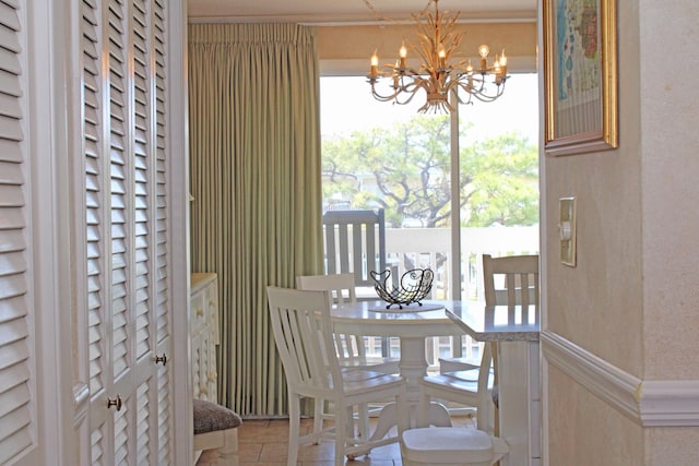 dining space featuring wainscoting and a notable chandelier