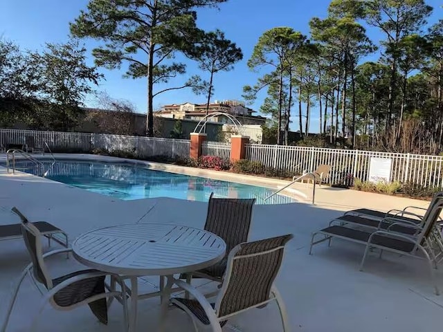 view of pool featuring a patio area, fence, and a fenced in pool