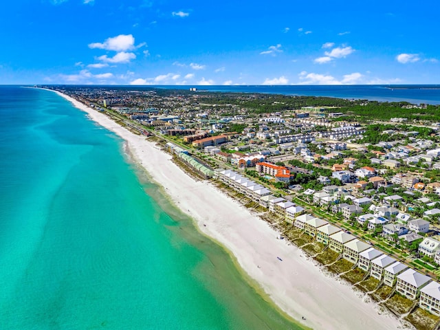 bird's eye view with a water view and a beach view