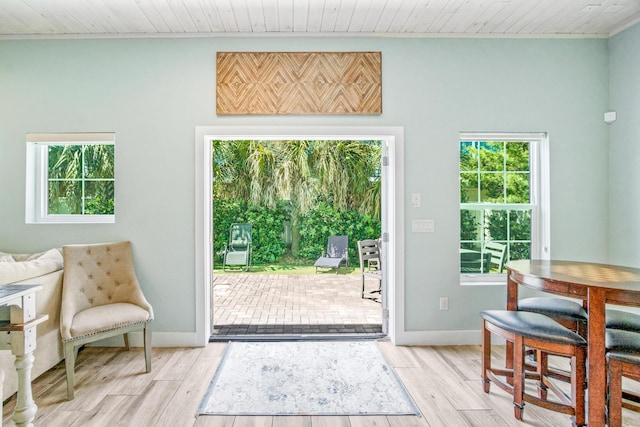 entryway featuring wooden ceiling, light wood-style flooring, and baseboards