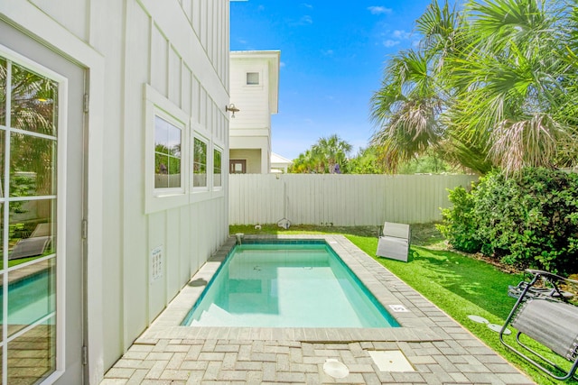 view of swimming pool featuring a fenced backyard, a fenced in pool, and a lawn