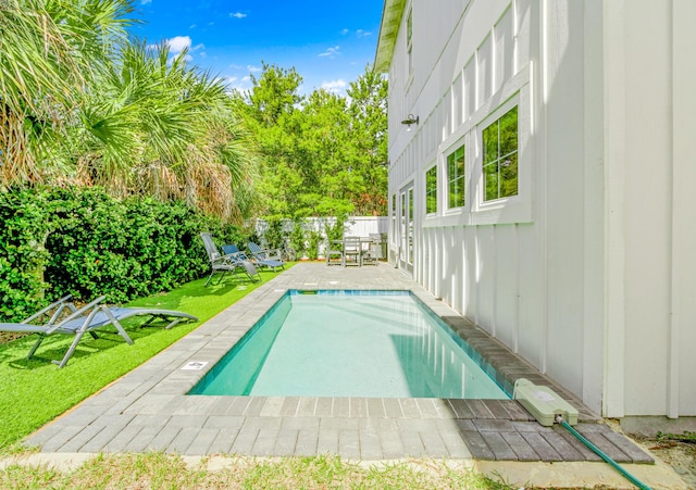 view of swimming pool featuring a yard, a patio area, a fenced backyard, and a fenced in pool