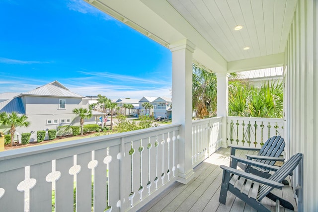 wooden terrace featuring covered porch and a residential view