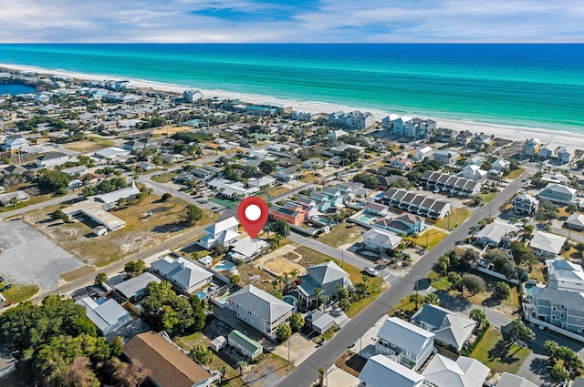 drone / aerial view with a water view and a beach view