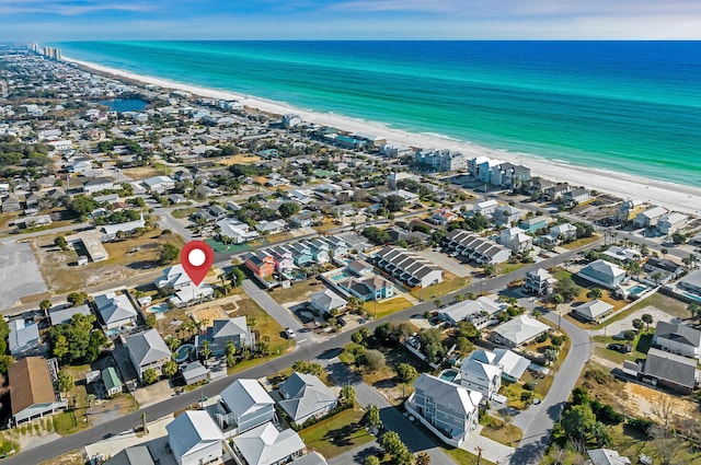 aerial view with a water view and a beach view