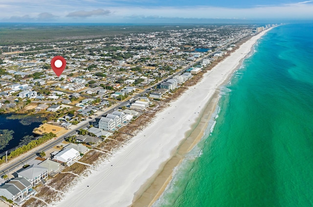 bird's eye view with a water view and a beach view