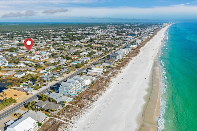 bird's eye view with a water view and a beach view