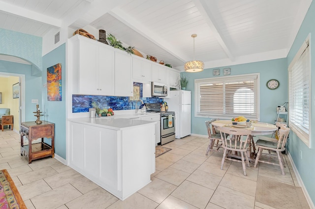 kitchen featuring white cabinetry, hanging light fixtures, vaulted ceiling with beams, stainless steel appliances, and decorative backsplash