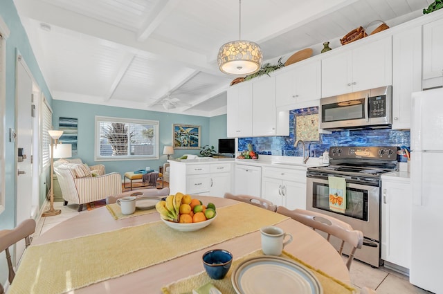 kitchen with pendant lighting, white cabinetry, stainless steel appliances, and decorative backsplash