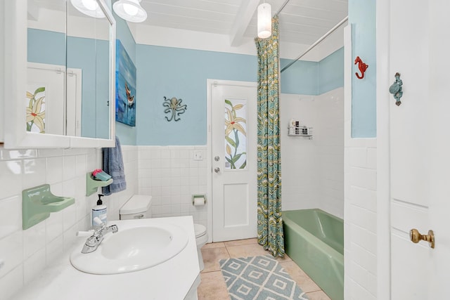 full bathroom with tile patterned floors, toilet, sink, tile walls, and shower / bath combination with curtain