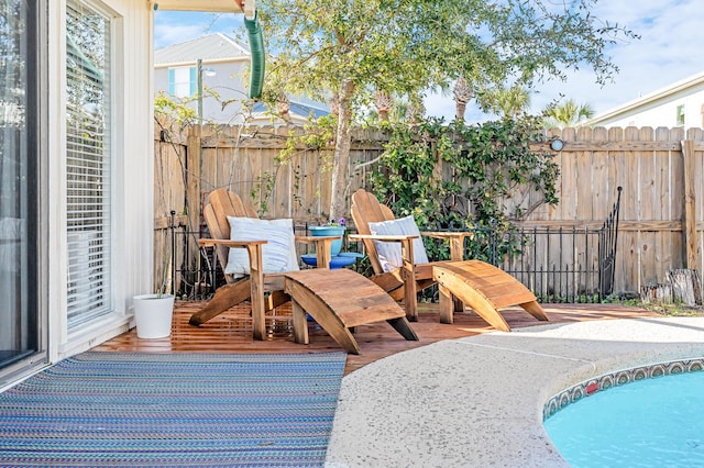 exterior space with a fenced in pool and a patio area