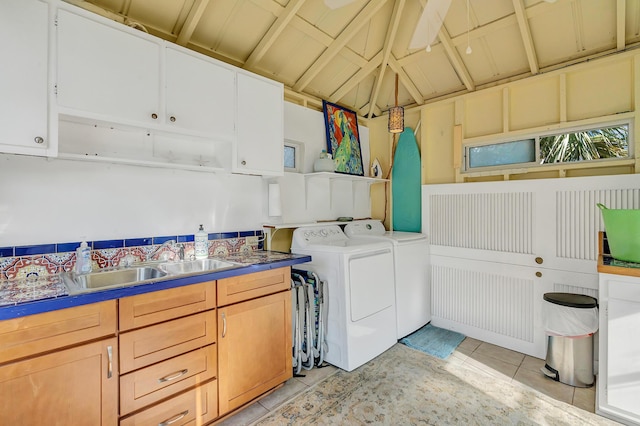 laundry room with sink, light tile patterned floors, cabinets, and washing machine and clothes dryer