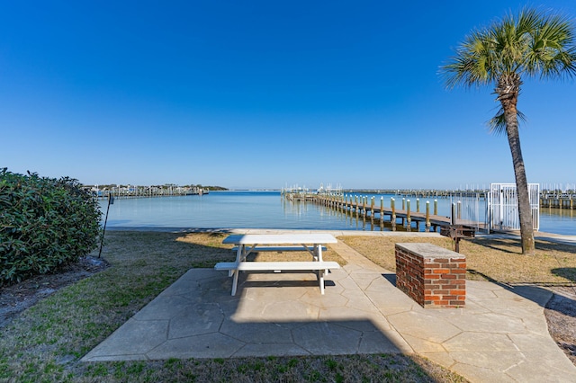 view of patio / terrace with a water view and a dock