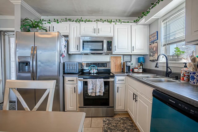 kitchen with stainless steel appliances, sink, and white cabinets