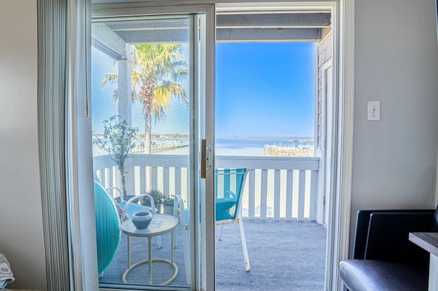 interior space with a water view and carpet floors