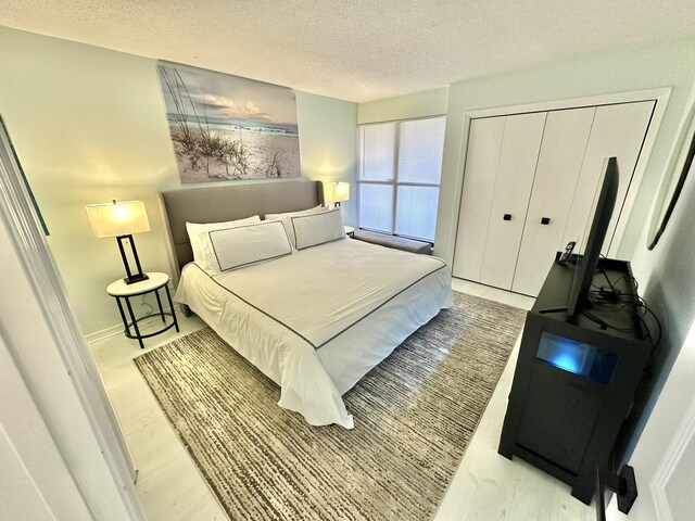 4045 Beachside One Dr # 4045, Miramar Beach, FL 32550 - bedroom with wood finished floors, a textured ceiling, and a closet