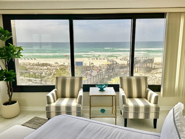 4045 Beachside One Dr # 4045, Miramar Beach, FL 32550 - bedroom with multiple windows, view of water and beach, baseboards, and wood finished floors