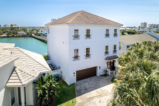 exterior space with a garage and a water view