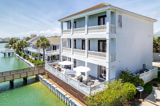 rear view of house featuring a water view