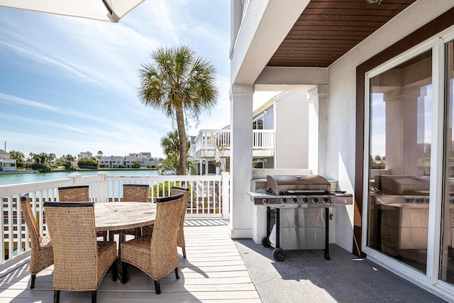 wooden deck featuring a grill and a water view