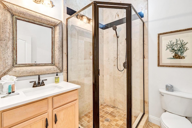 bathroom featuring vanity, toilet, and walk in shower