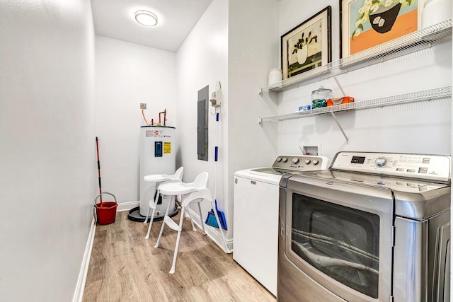 clothes washing area with washing machine and dryer, electric water heater, and light hardwood / wood-style flooring