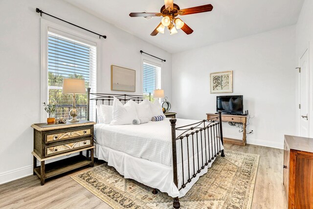 bedroom with ceiling fan and light hardwood / wood-style floors