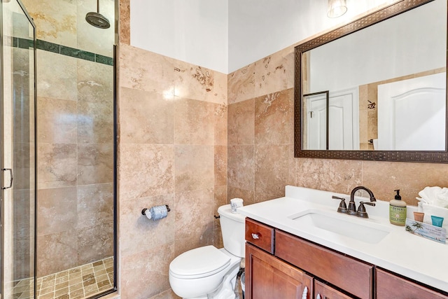 bathroom featuring walk in shower, vanity, toilet, and tile walls