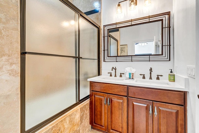 bathroom with vanity and shower / bath combination with glass door