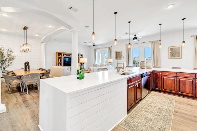 kitchen with ceiling fan, sink, hanging light fixtures, and light hardwood / wood-style flooring