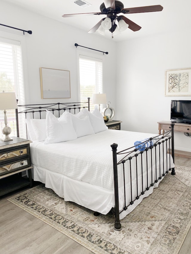 bedroom with ceiling fan and light wood-type flooring