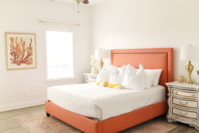 bedroom with hardwood / wood-style floors and ceiling fan