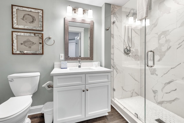 bathroom with vanity, wood-type flooring, an enclosed shower, and toilet