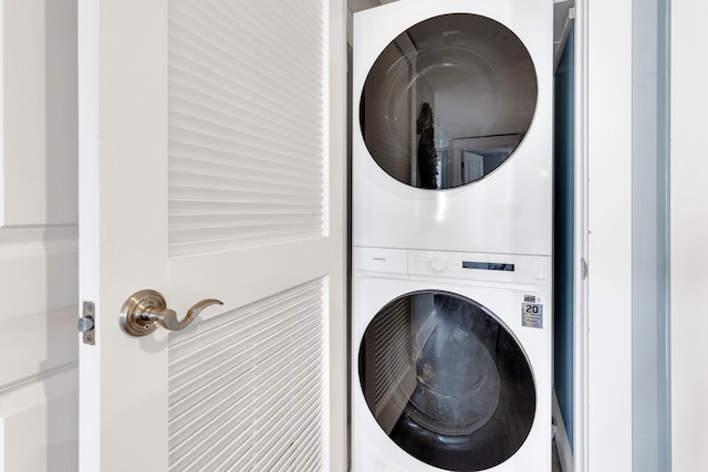 laundry area featuring stacked washing maching and dryer