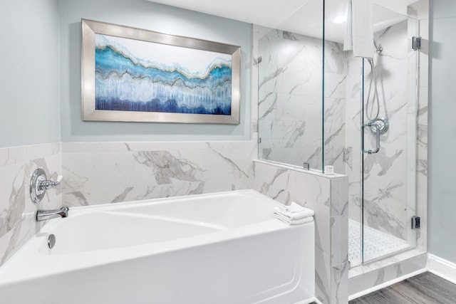 bathroom featuring hardwood / wood-style flooring and plus walk in shower