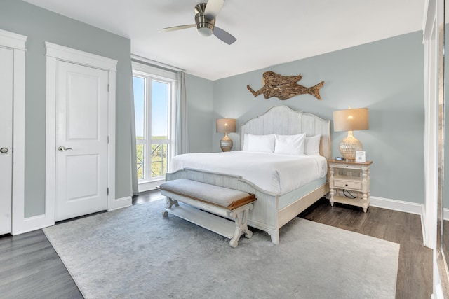 bedroom with ceiling fan and dark hardwood / wood-style floors