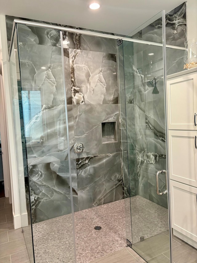 bathroom with a shower with shower door