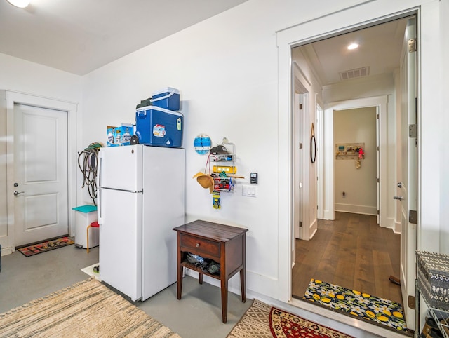 kitchen featuring concrete flooring and white refrigerator