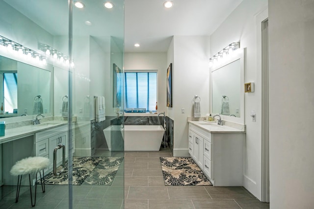 bathroom featuring vanity and a tub to relax in