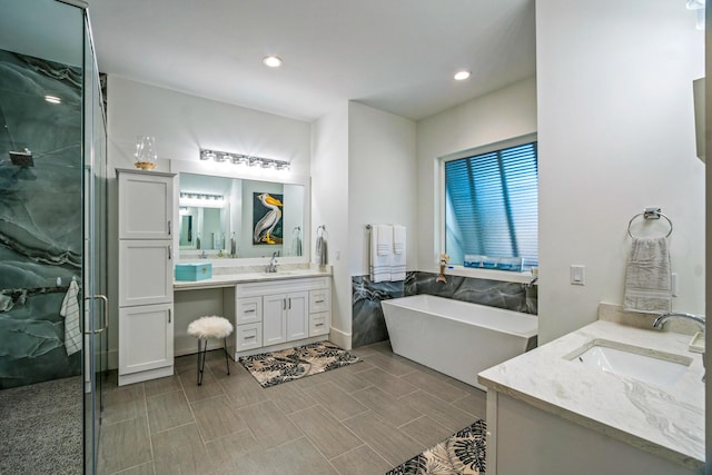 bathroom featuring independent shower and bath and vanity