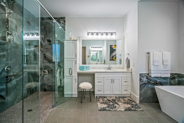 bathroom featuring vanity and separate shower and tub